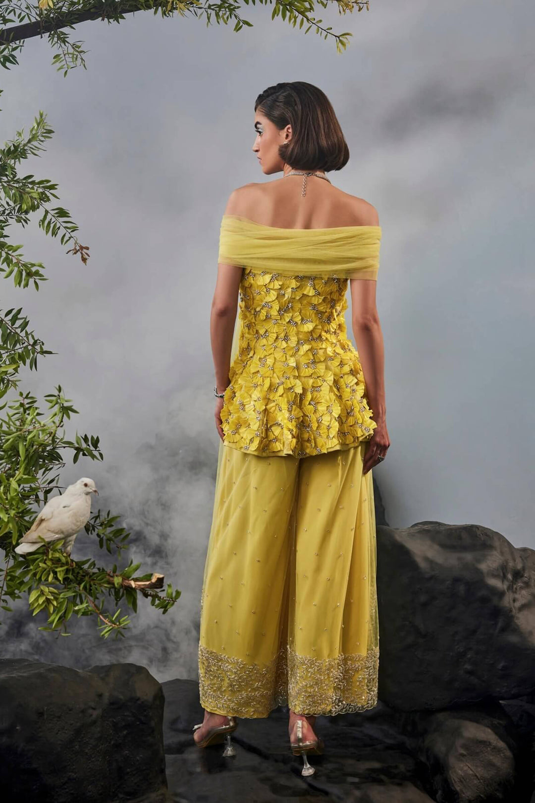 Feather Embellished Peplum Top With Wide Legged Trousers And Shoulder Drape