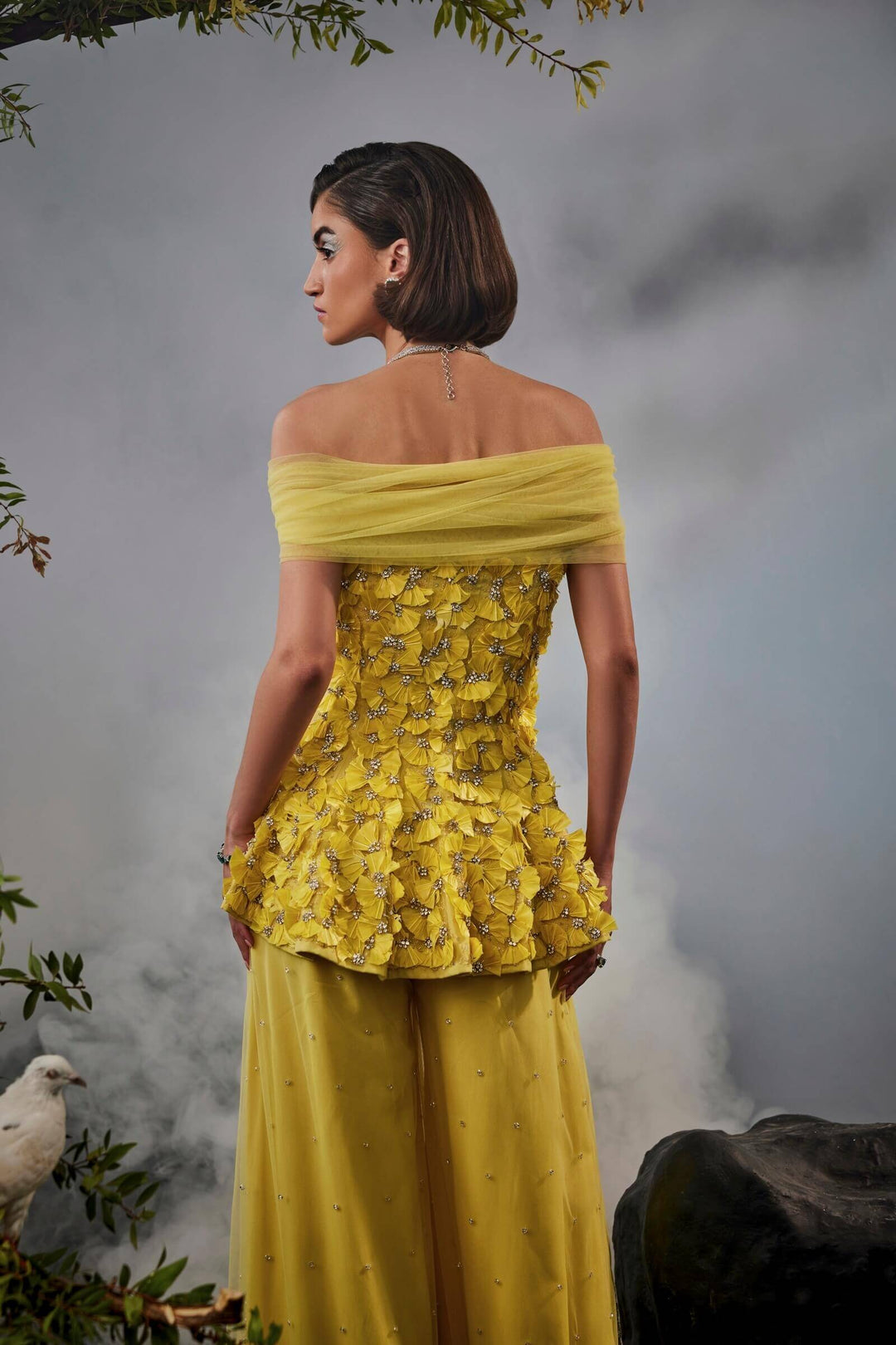 Feather Embellished Peplum Top With Wide Legged Trousers And Shoulder Drape